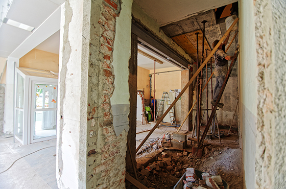 construction worker on a ladder working on a new home addition